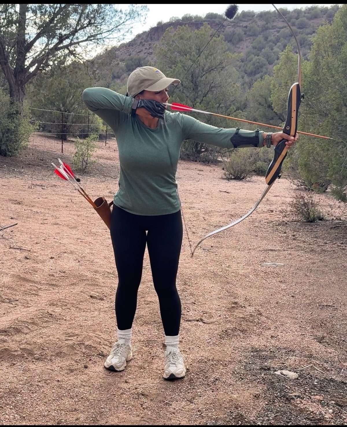 Paola with recurve bow in the desert