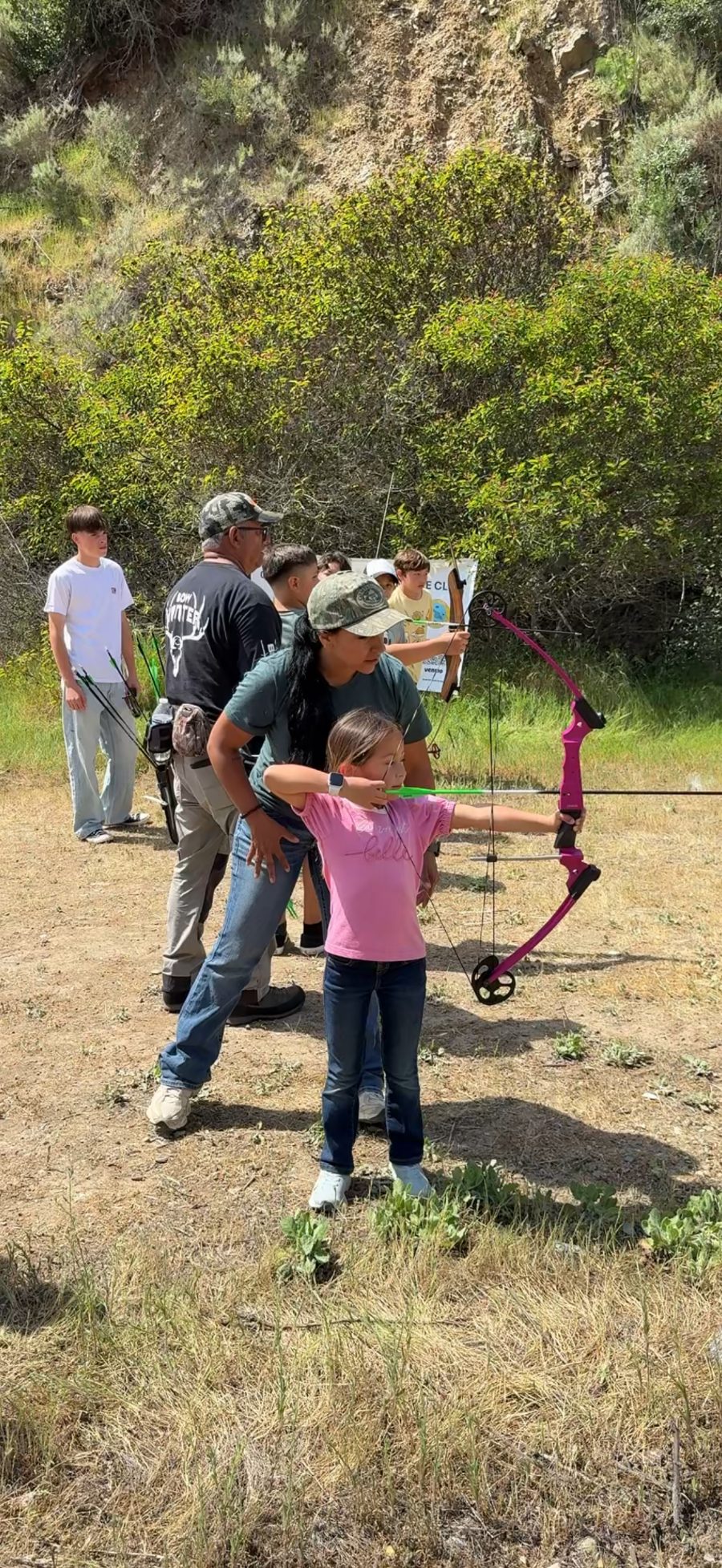 Teaching a girl archery